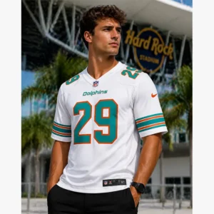 male model wearing the white Miami Dolphins Storm Duck number 29 game jersey standing in front of Hard Rock Stadium.