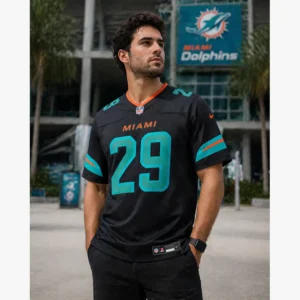 male model wearing a black Miami Dolphins jersey number 29 in front of a stadium, demonstrating a casual lifestyle