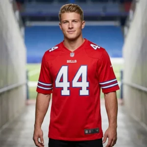 A male model wearing a red Buffalo Bills #44 jersey standing in a stadium tunnel.
