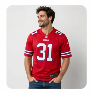 A smiling male model wearing a red Buffalo Bills #31 Taron Johnson home jersey paired with blue jeans against a clean white background.