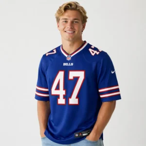 A male model wearing the Christian Benford #47 Buffalo Bills Royal Nike Game Jersey in a lifestyle setting.