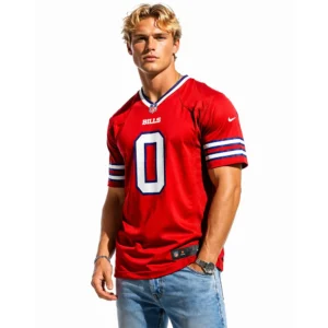 Stylish blonde male model wearing the Keon Coleman Buffalo Bills red alternate jersey, paired with blue jeans and silver jewelry.