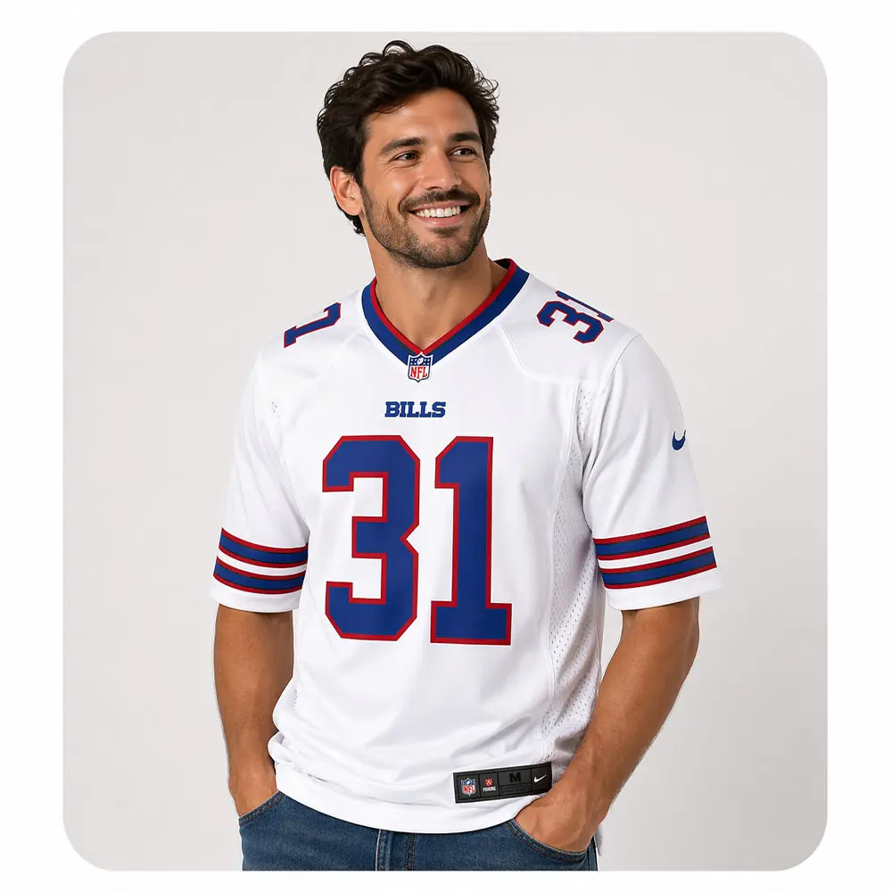 maxwell-hairston-bills-away-jersey-lifestyle A smiling man wearing the Maxwell Hairston #31 Buffalo Bills away white jersey from the 2026 Essential Collection.